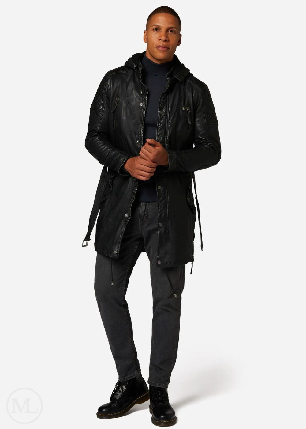 Man wearing a black leather coat and pants on a white background