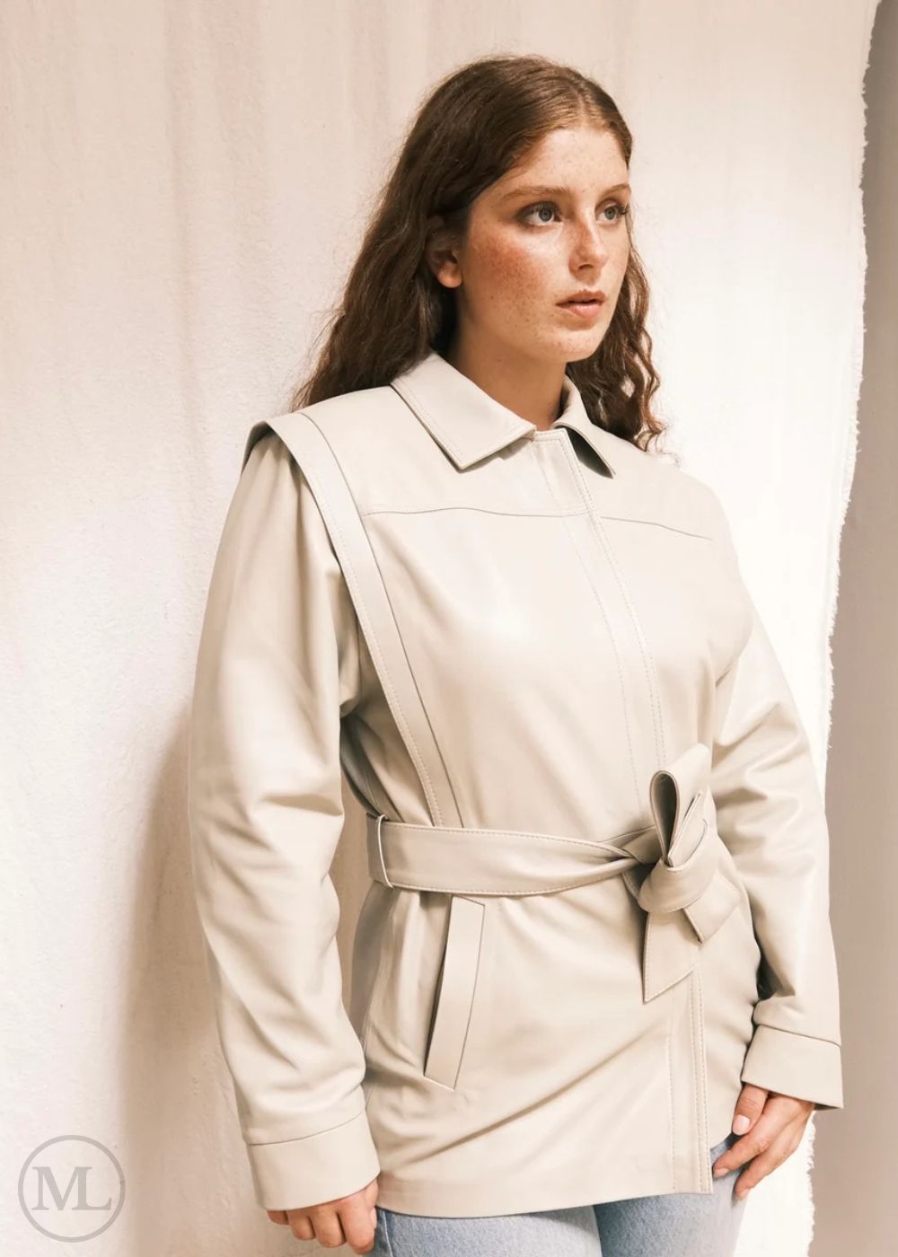 Woman wearing a Lvory Leather coat against a plain background